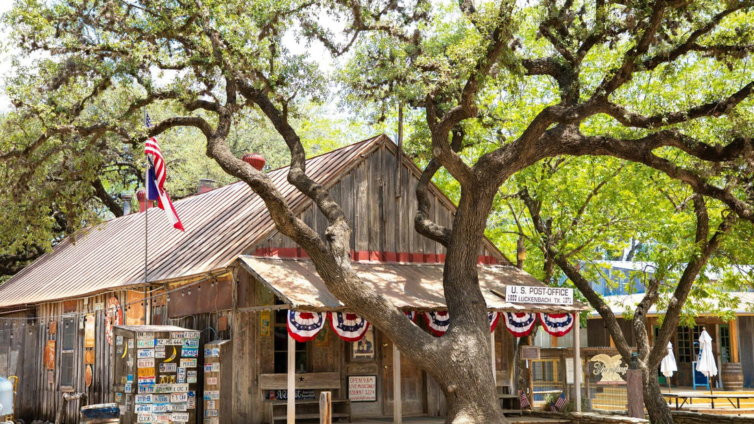 Rustic Hill Country building in Central Texas with oak trees and Texas flags on a quiet small town street