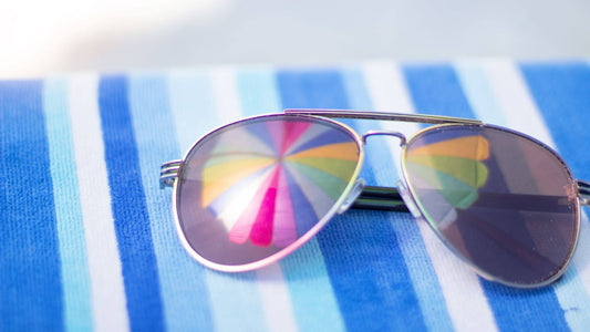 Sunglasses resting on a striped beach towel during a quiet Texas coast getaway before the summer crowds arrive.