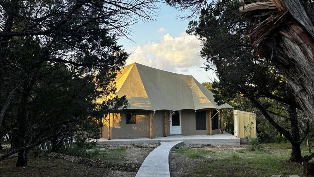 Serafina luxury safari tent at SINYA on Lone Man Creek, surrounded by trees in the Texas Hill Country near Wimberley.